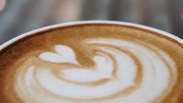 latte art heart shape of hot coffee drink in cup