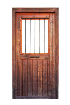 A wooden door with a window and vertical iron bars