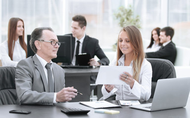 employees using digital tablet to work with financial data