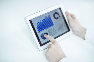 businessman using digital tablet, working with the financial schedule at the Desk