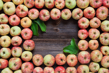 Fresh red apples on wooden background in vintage stile.  Close-up, top view, space for your text