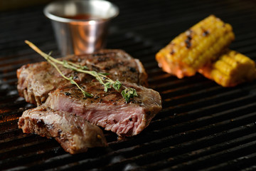 Grilled meat with vegetables and sauce, on the grill