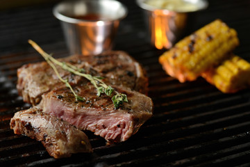 Grilled meat with vegetables and sauce, on the grill