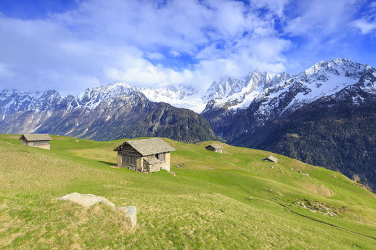Traditional huts with Pizzo Badile in the background, Soglio, Val Bregaglia (Bregaglia Valley), Graubunden