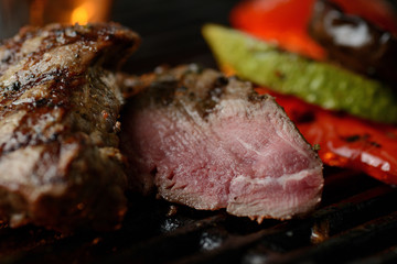 Grilled meat with vegetables and sauce, on the grill
