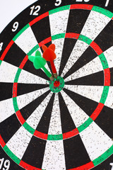 closeup. several Arrows dart hitting the center of the target d