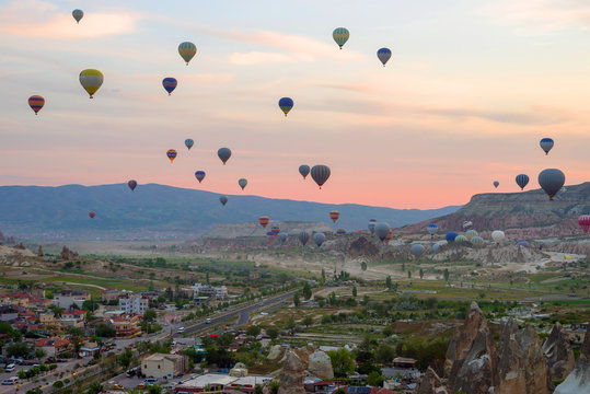Hot air balloons at sunrise flying over Cappadocia, Goreme, Turkey.