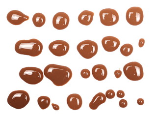 Set drops, spilled chocolate milk puddle isolated on white background, top view