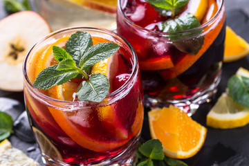 Sangria with fruit, ice and mint in glass. 