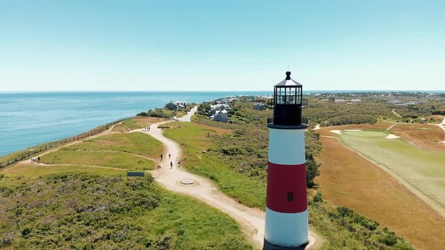 Aerial drone shot of a coastal lighthouse on Nantucket island in Massachusetts.