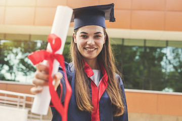 Young female student graduating from university