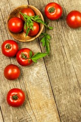Fresh tomatoes on an old wooden table. Growing of fruits and vegetables. Healthy food. Raw vegetarian food. Sale of tomatoes.