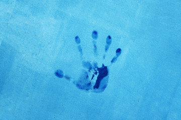 handprint on a blue wall