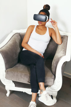 woman on a sofa wearing virtual reality set