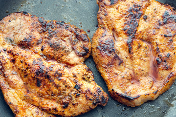 Fried pork in a pan. Preparation of pork in a pan before baking in the oven. Shallow depth of field.