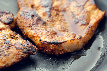 Fried pork in a pan. Preparation of pork in a pan before baking in the oven. Shallow depth of field.