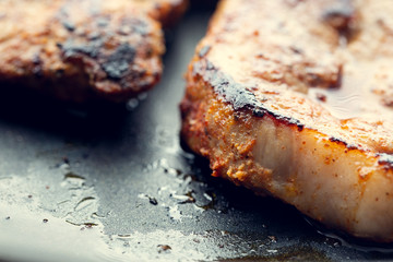 Fried pork in a pan. Preparation of pork in a pan before baking in the oven. Shallow depth of field.