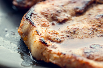 Fried pork in a pan. Preparation of pork in a pan before baking in the oven. Shallow depth of field.