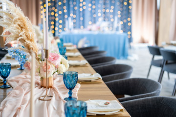 Wedding Banquet or gala dinner. The chairs and table for guests, served with cutlery and crockery....