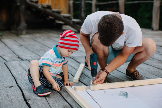 Man and son busy with carpentry