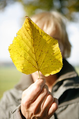 Frau hält Herbstblatt
