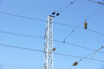 high-voltage power tower against the blue sky