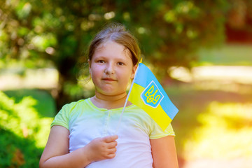 a beautiful girl with love holding a flag of ukraine a summer day