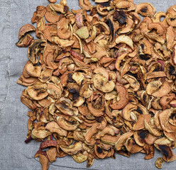 dry apple slices on a gray linen napkin