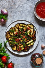 Spicy eggplant with tomato sauce and cilantro. Grilled eggplant.