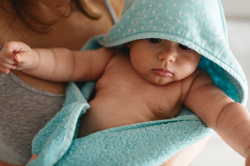 Mother drying off baby after a bath.