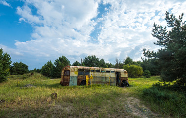 Fototapeta na wymiar Abandoned and rusty bus in Chernobyl zone