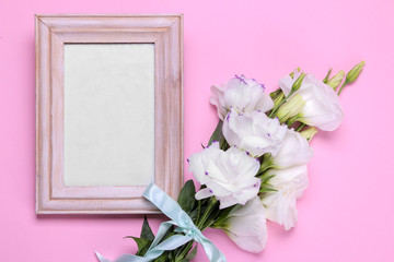 Beautiful white bouquet of eustoma with frame for photo on a bright pink background top view