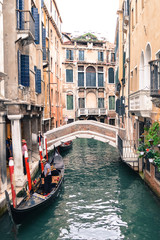 Venice, Italy-September 28, 2013: narrow Strait, bridge, gondola and gondoliers.