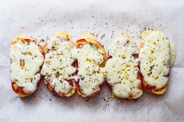 Hot homemade grilled sandwiches with cheese and meat on white paper top view