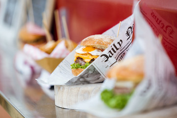 Different types of hamburger on the shelf of a food truck.