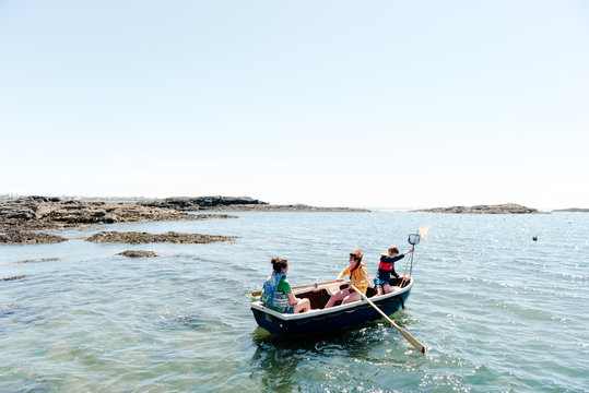 kids on rowboat at sea