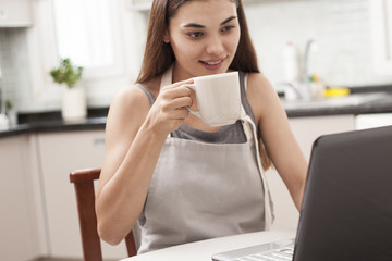 woman reading news at the kitchen