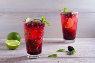 Blackberry mojito cocktail with berries, lime and mint. Summer berry cocktail