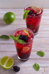 Blackberry mojito cocktail with berries, lime and mint. Summer berry cocktail
