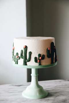 Cake decorated with cacti on cakestand