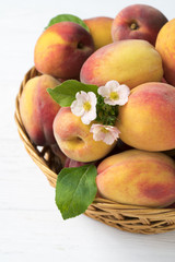 .Peaches with leaves in a basket