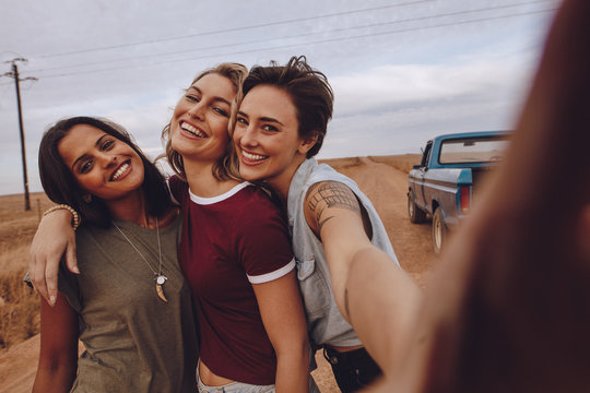 Women on road trip taking selfie