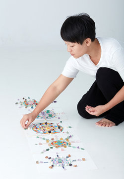 Mandala pattern with crystal and Asian women. a creator