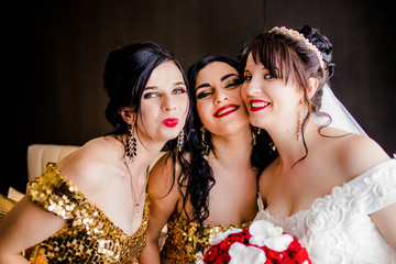 Sweet bride and girlfriend hugging each others in the apartment