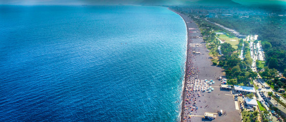 Aerial view of beautiful blue gulf and long Konyaalti beach in Antalya, Turkey. Antalya is Turkey's biggest international sea resort located on Turkish Riviera.