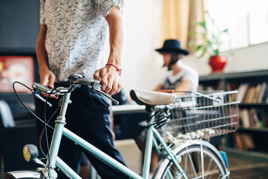 Closeup of a creative man with his bicycle at office.