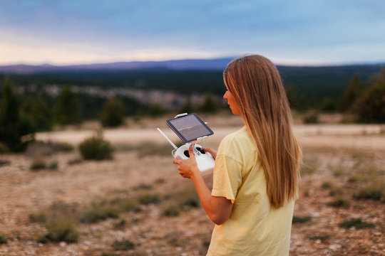 Woman flying drone at mountains