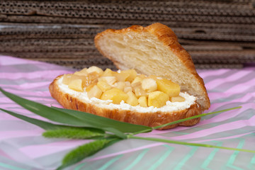 Homemade croissant with sliced apple and ricotta cheese