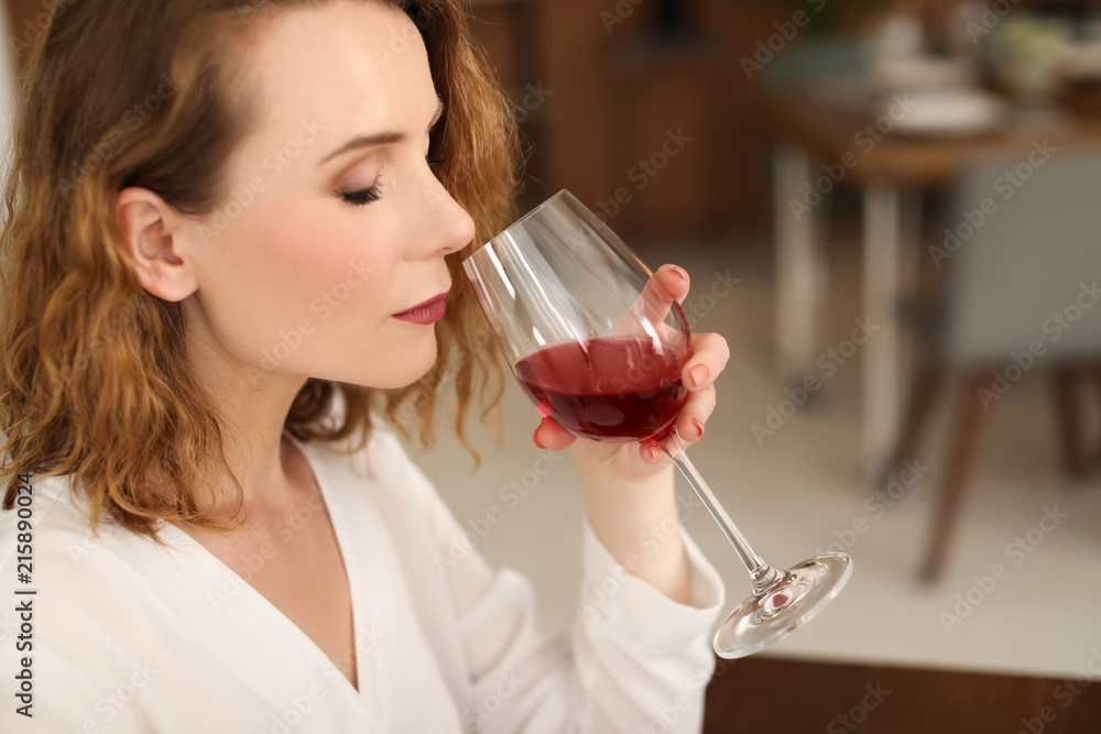 Wall mural Woman with glass of delicious wine indoors