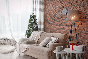 Decorated Christmas tree in stylish living room interior